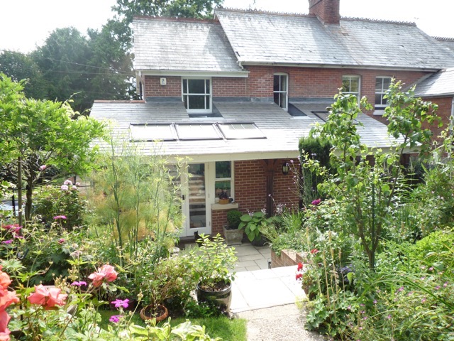 Single storey wraparound extension incorporating vaulted ceilings with roof windows.